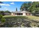 Spacious backyard with green grass and a screened lanai at 144 Fort Smith Blvd, Deltona, FL 32738