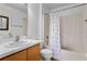Standard bathroom with a combination tub and shower and a vanity with wooden cabinets at 144 Fort Smith Blvd, Deltona, FL 32738