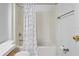 Full bathroom with tub and shower with curtain, along with toilet and hardware at 144 Fort Smith Blvd, Deltona, FL 32738