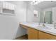 Neat bathroom featuring a white vanity, large mirror, and a walk-in shower at 144 Fort Smith Blvd, Deltona, FL 32738