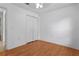 Clean bedroom featuring hardwood floors, a ceiling fan, and a double-door closet at 144 Fort Smith Blvd, Deltona, FL 32738