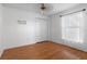 Bedroom with hardwood floors, a ceiling fan, a window with curtains, and a closet at 144 Fort Smith Blvd, Deltona, FL 32738
