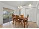 Dining area featuring tile floors, a wooden dining set, and sliding glass doors at 144 Fort Smith Blvd, Deltona, FL 32738