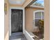 Welcoming front entrance features a modern black door with sidelight and charming exterior accents at 144 Fort Smith Blvd, Deltona, FL 32738