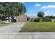 Cozy single-story home with an attached garage, driveway, and a well-kept lawn at 144 Fort Smith Blvd, Deltona, FL 32738