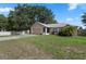 Quaint single-story home with an attached garage and a lush, green lawn at 144 Fort Smith Blvd, Deltona, FL 32738