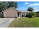 Charming single-story home features an attached garage, well-maintained lawn, and delightful landscaping at 144 Fort Smith Blvd, Deltona, FL 32738