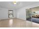 Open-concept living area with neutral tile floors and sliding glass doors to the screened-in lanai at 144 Fort Smith Blvd, Deltona, FL 32738
