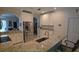 Bright kitchen featuring stainless steel appliances, granite countertops, and white cabinetry for a clean aesthetic at 148 Peregrine Ct, Winter Springs, FL 32708