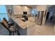 A modern kitchen with stainless steel appliances, granite countertops, and a stylish breakfast bar at 148 Peregrine Ct, Winter Springs, FL 32708