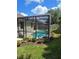 The screened in pool is surrounded by lush landscaping creating a private outdoor oasis for relaxation at 148 Peregrine Ct, Winter Springs, FL 32708