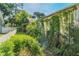A view of a house overgrown with foliage, with plants covering the walls and surrounding areas at 1511 Center Ave, Holly Hill, FL 32117