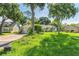 Wide shot of home from lawn, showing garage and neighboring homes at 1511 Center Ave, Holly Hill, FL 32117