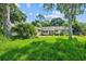 A charming single-story house surrounded by lush greenery and mature trees at 1511 Center Ave, Holly Hill, FL 32117