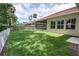 Exterior view of the home's backyard and screened-in patio with a white fence at 1679 Shadowmoss Cir, Lake Mary, FL 32746