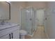 Bright bathroom with a glass-enclosed shower, a white marble vanity, and neutral tile flooring at 1679 Shadowmoss Cir, Lake Mary, FL 32746