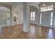 Elegant entryway with tile flooring, arched doorways, and view of the kitchen at 1679 Shadowmoss Cir, Lake Mary, FL 32746