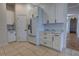 A clean kitchen features white cabinets, stainless appliances, and marble countertops at 1679 Shadowmoss Cir, Lake Mary, FL 32746