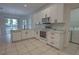 Modern kitchen featuring white cabinets, stainless steel appliances, and tile flooring at 1679 Shadowmoss Cir, Lake Mary, FL 32746