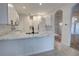 Modern kitchen features white cabinets, marble countertops, and stainless steel appliances at 1679 Shadowmoss Cir, Lake Mary, FL 32746