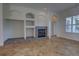 Cozy living room featuring a fireplace, built-in shelving, and tile floors at 1679 Shadowmoss Cir, Lake Mary, FL 32746