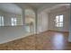 Bright living room showcasing arched doorways to the kitchen and great natural light from large windows at 1679 Shadowmoss Cir, Lake Mary, FL 32746