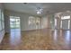 Open-concept living room with tile flooring, arched doorways, and access to outdoor patio at 1679 Shadowmoss Cir, Lake Mary, FL 32746