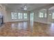 Spacious living room with tile floors, large windows, and a sliding glass door at 1679 Shadowmoss Cir, Lake Mary, FL 32746