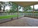 Covered patio featuring tile flooring and views of the fenced backyard with mature trees at 1679 Shadowmoss Cir, Lake Mary, FL 32746
