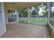 Covered patio featuring tile flooring and views of the fenced backyard with mature trees at 1679 Shadowmoss Cir, Lake Mary, FL 32746