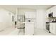 White kitchen with center island, stainless appliances, and views into the living room at 2137 Lasso Loop, Eagle Lake, FL 33839