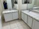 A bathroom featuring dual sinks and mirrors, offering functionality and style for a well-appointed space at 2149 Mallard Creek Cir, Kissimmee, FL 34743
