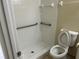 Bathroom includes a walk-in shower, grab bars, and a white toilet at 2149 Mallard Creek Cir, Kissimmee, FL 34743