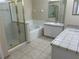 Well-lit bathroom with dual sinks, a soaking tub, and a separate glass-enclosed shower for a luxurious experience at 2149 Mallard Creek Cir, Kissimmee, FL 34743