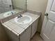 Bathroom vanity featuring a tile countertop and white cabinet at 2149 Mallard Creek Cir, Kissimmee, FL 34743