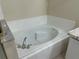 Close up on a bathroom tub, showcasing the fixture and the surrounding tilework for a detailed view at 2149 Mallard Creek Cir, Kissimmee, FL 34743