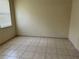 A quiet bedroom with tile flooring, a window for natural light, and neutral walls create a calming retreat at 2149 Mallard Creek Cir, Kissimmee, FL 34743
