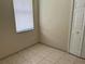 Neutral bedroom featuring tile flooring, and a large window with blinds at 2149 Mallard Creek Cir, Kissimmee, FL 34743
