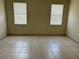 Spacious bedroom with tile flooring, neutral walls, two windows offering plenty of natural light at 2149 Mallard Creek Cir, Kissimmee, FL 34743