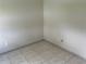Neutral bedroom with tile floors and base trim at 2149 Mallard Creek Cir, Kissimmee, FL 34743