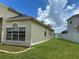 Home exterior showcasing a well-manicured lawn, window details, and a clean white fence at 2149 Mallard Creek Cir, Kissimmee, FL 34743