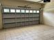 Tiled interior of a one car garage. The garage door is partly open at 2149 Mallard Creek Cir, Kissimmee, FL 34743
