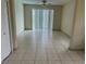 Bright living room featuring tiled floors, ceiling fan, and a sliding glass door that provides ample natural light at 2149 Mallard Creek Cir, Kissimmee, FL 34743