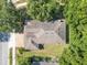 An aerial view shows the roof and landscaping of the home within a tree-lined neighborhood at 216 Homestretch Blvd, Deland, FL 32724