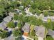 Overview of a community with mature trees, swimming pool, and well-maintained landscaping at 216 Homestretch Blvd, Deland, FL 32724