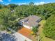 A home featuring a brick driveway and mature landscaping in a lush, green area at 216 Homestretch Blvd, Deland, FL 32724