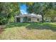 Beautifully maintained backyard featuring lush green grass and mature shade trees at 216 Homestretch Blvd, Deland, FL 32724