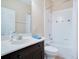 Bathroom with shower-tub combo with decorative tile accents and a vanity at 216 Homestretch Blvd, Deland, FL 32724