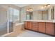 Bright bathroom featuring a double vanity, soaking tub, and a glass-enclosed shower at 216 Homestretch Blvd, Deland, FL 32724
