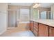 Bright bathroom featuring a double vanity, soaking tub, and a glass-enclosed shower at 216 Homestretch Blvd, Deland, FL 32724